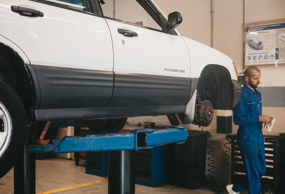 An ASE-certified technician working on a vehicle at Ironline Auto Repair