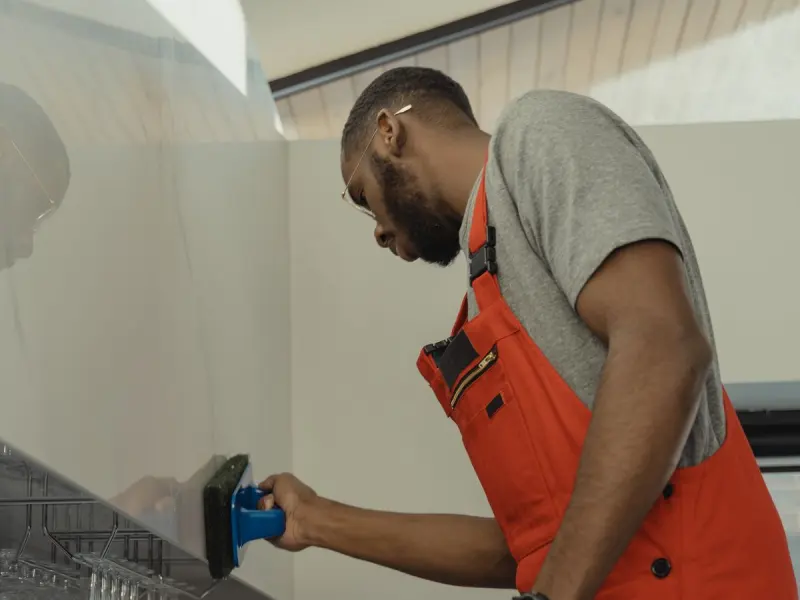 Cleaning technician wiping interior glass in a commercial building
