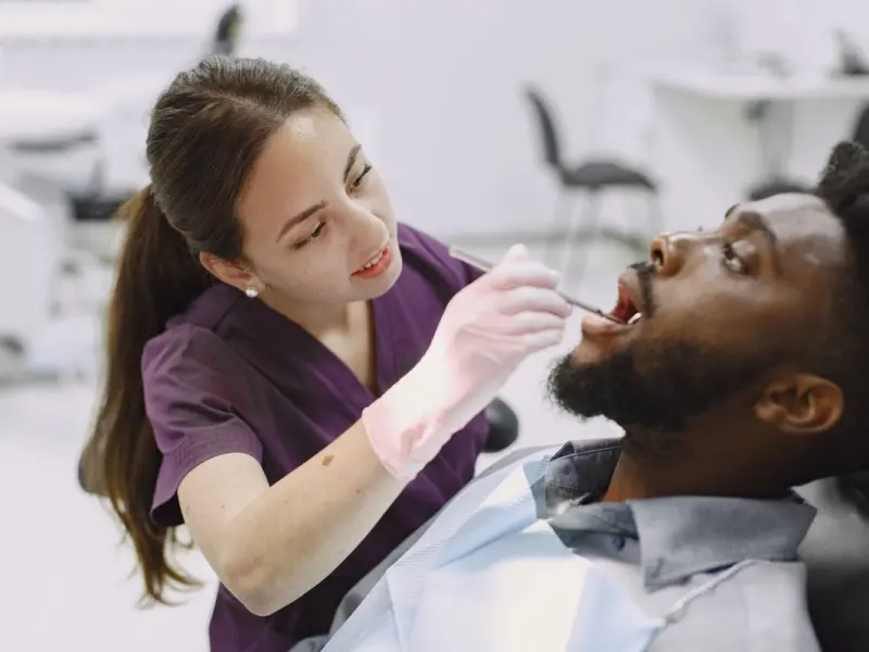 Dental hygienist performing a routine cleaning and checkup