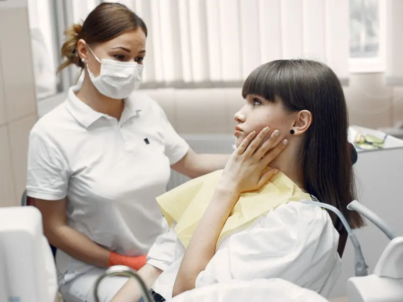 Patient with tooth pain being examined during an emergency dental visit