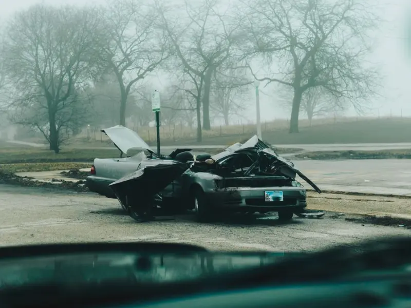 Severely damaged vehicle at the scene of a motor vehicle collision