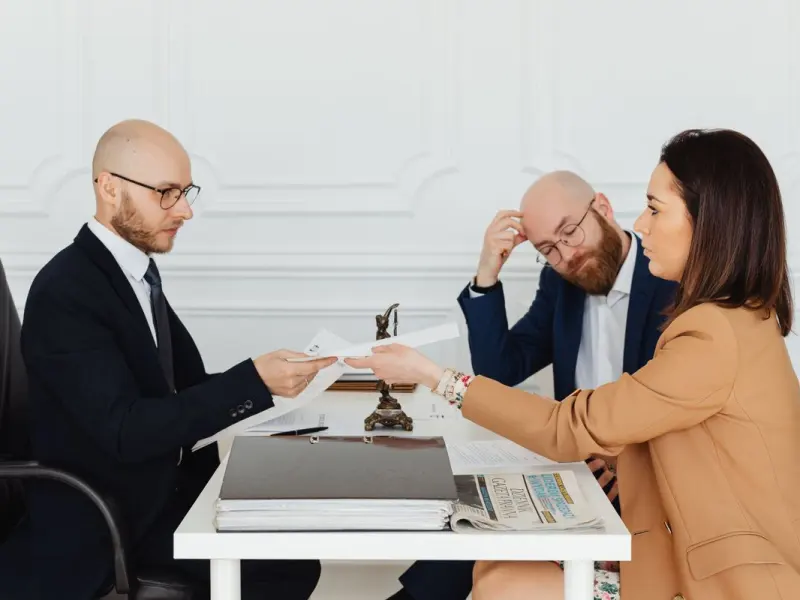 Attorneys reviewing legal documents with a client at Halbrook and Vance