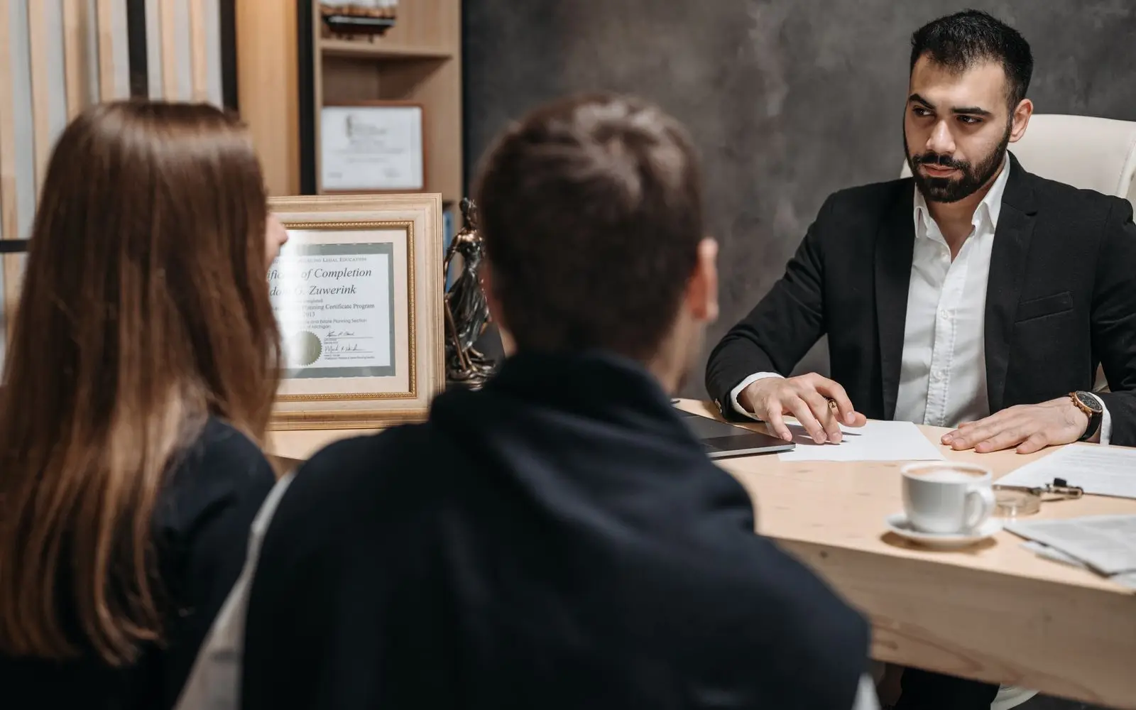 Attorney meeting with clients across a desk at Halbrook and Vance law offices