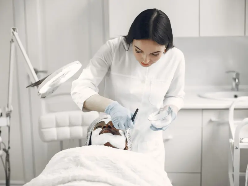 Laser and light-based skin treatment being performed in a clinical setting