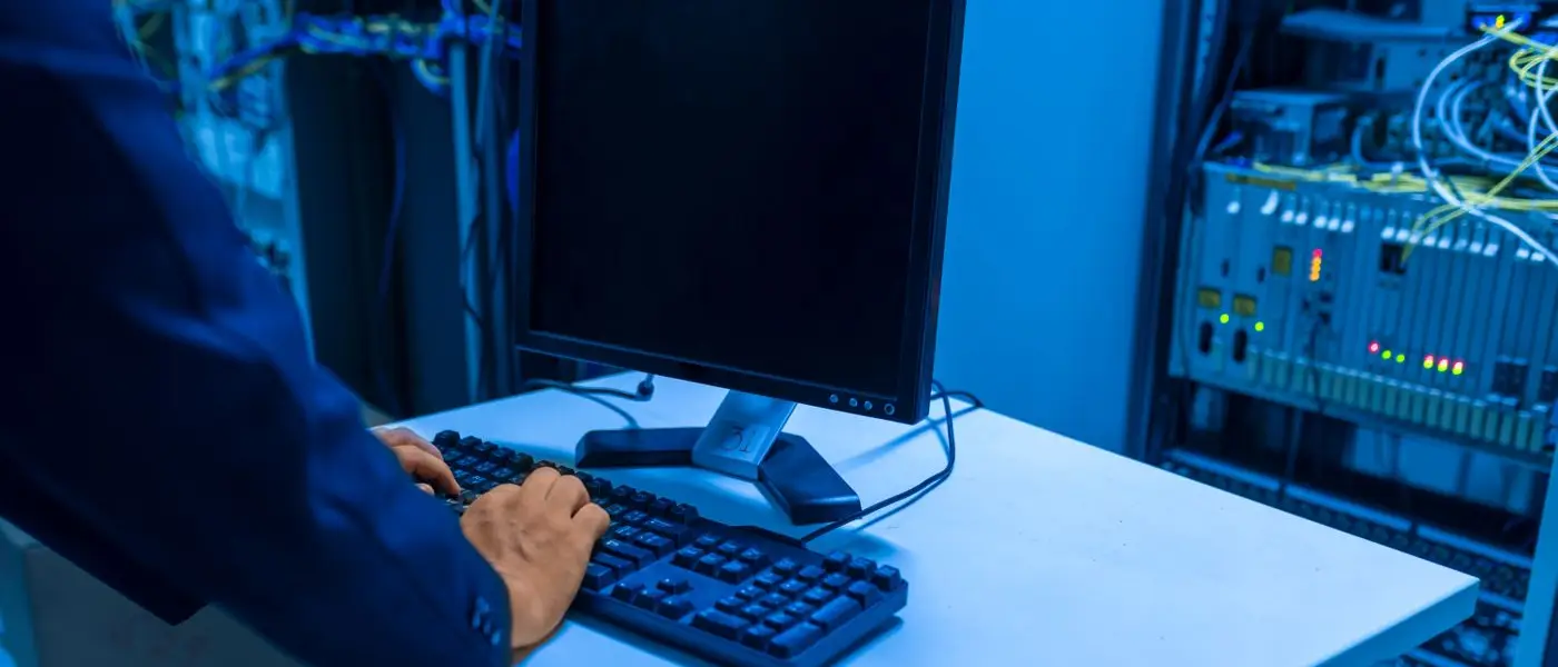 IT technician working in a data centre server room