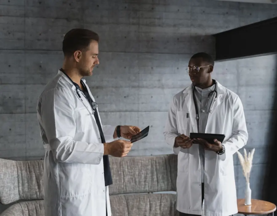 Two board-certified plastic surgeons reviewing a patient case together