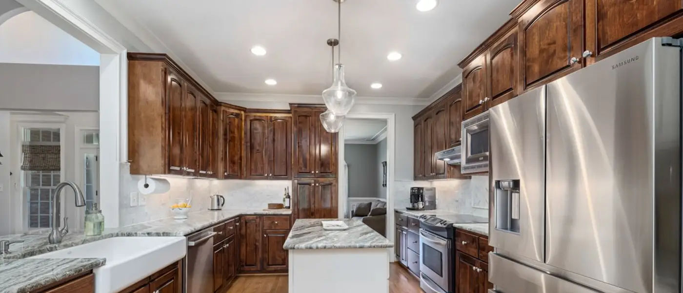 Completed kitchen renovation with wooden cabinetry by Fieldhouse Renovation