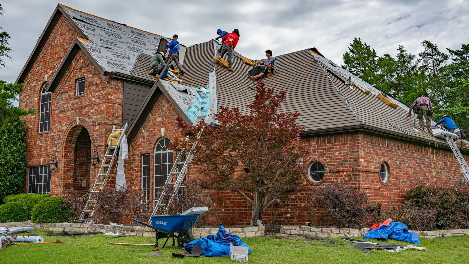 Summit Ridge roofing crew installing a new shingle roof on a brick home in Fort Worth