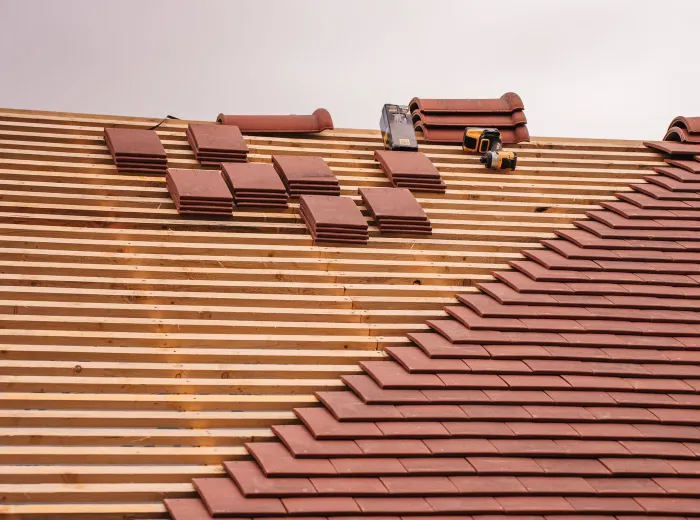 Terracotta clay tile roof installation in progress on a North Texas home