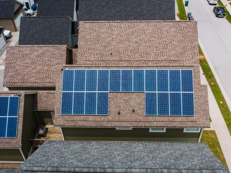 Aerial view of residential rooftop solar panel installations