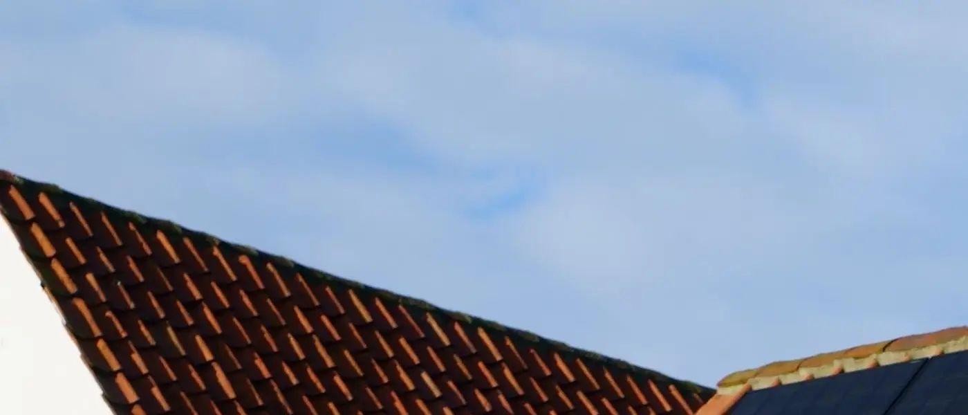 Rooftop solar panel array installed on a tiled roof