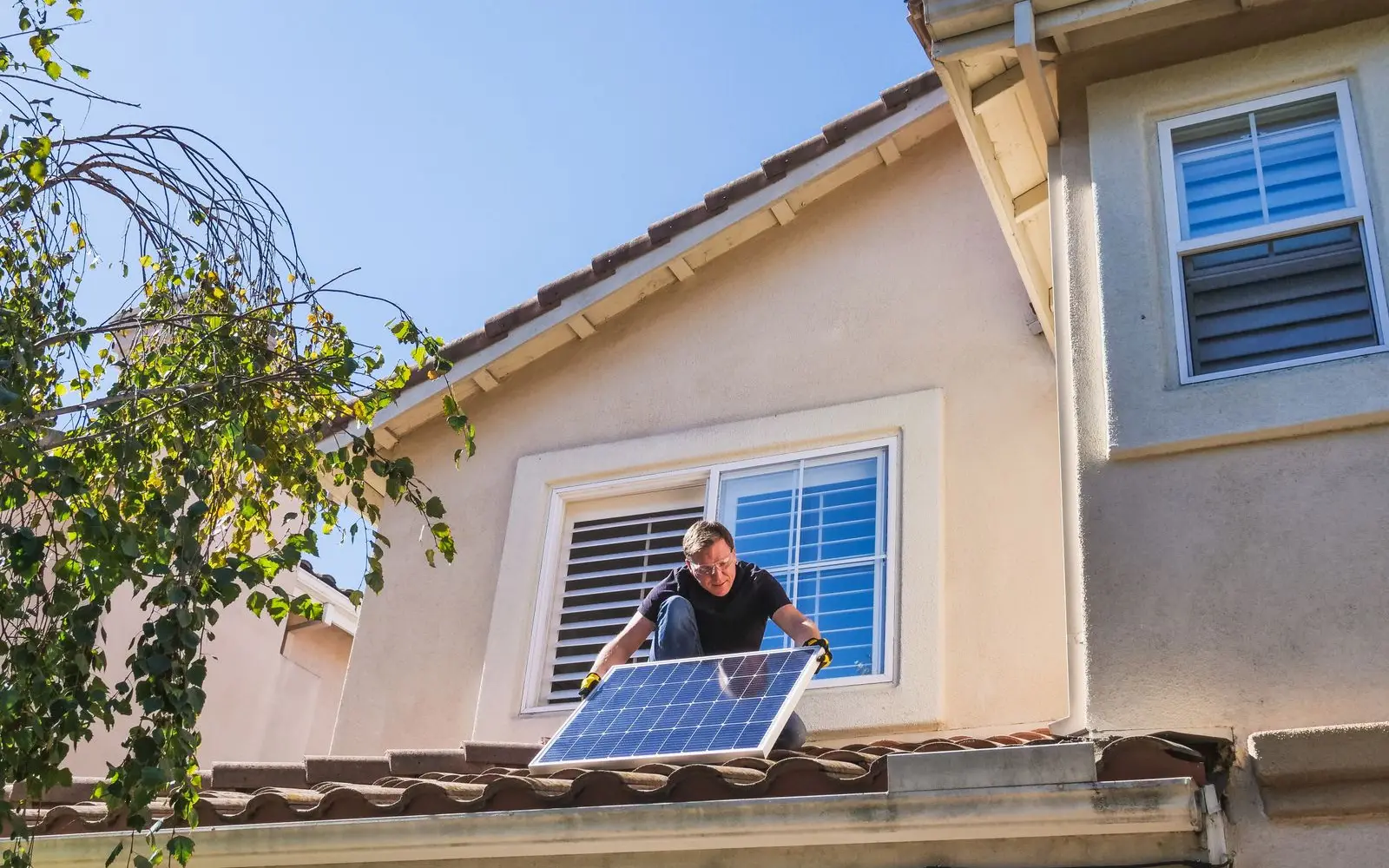 Meridian Solar technician installing photovoltaic panels on a residential roof